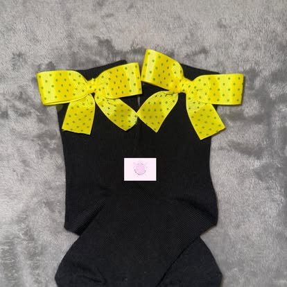 Black socks with yellow polka-dot ribbon bows