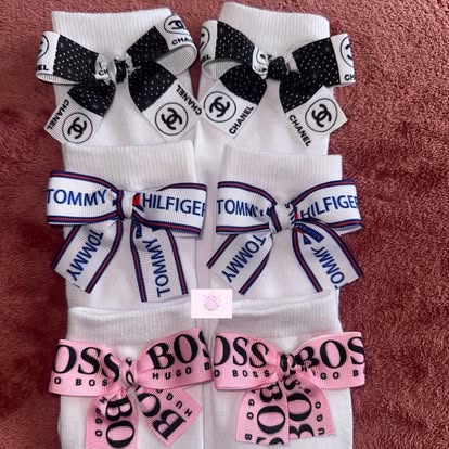 Three pairs of white socks with designer ribbon bows — Chanel, Tommy Hilfiger, Hugo Boss