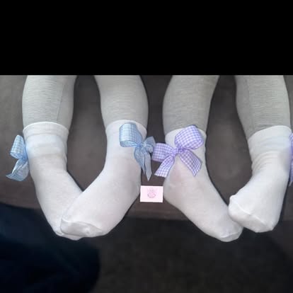 Three pairs of white socks with pastel gingham bows in blue and lilac